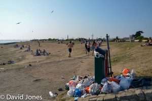 Overfull waste bin and plastic waste