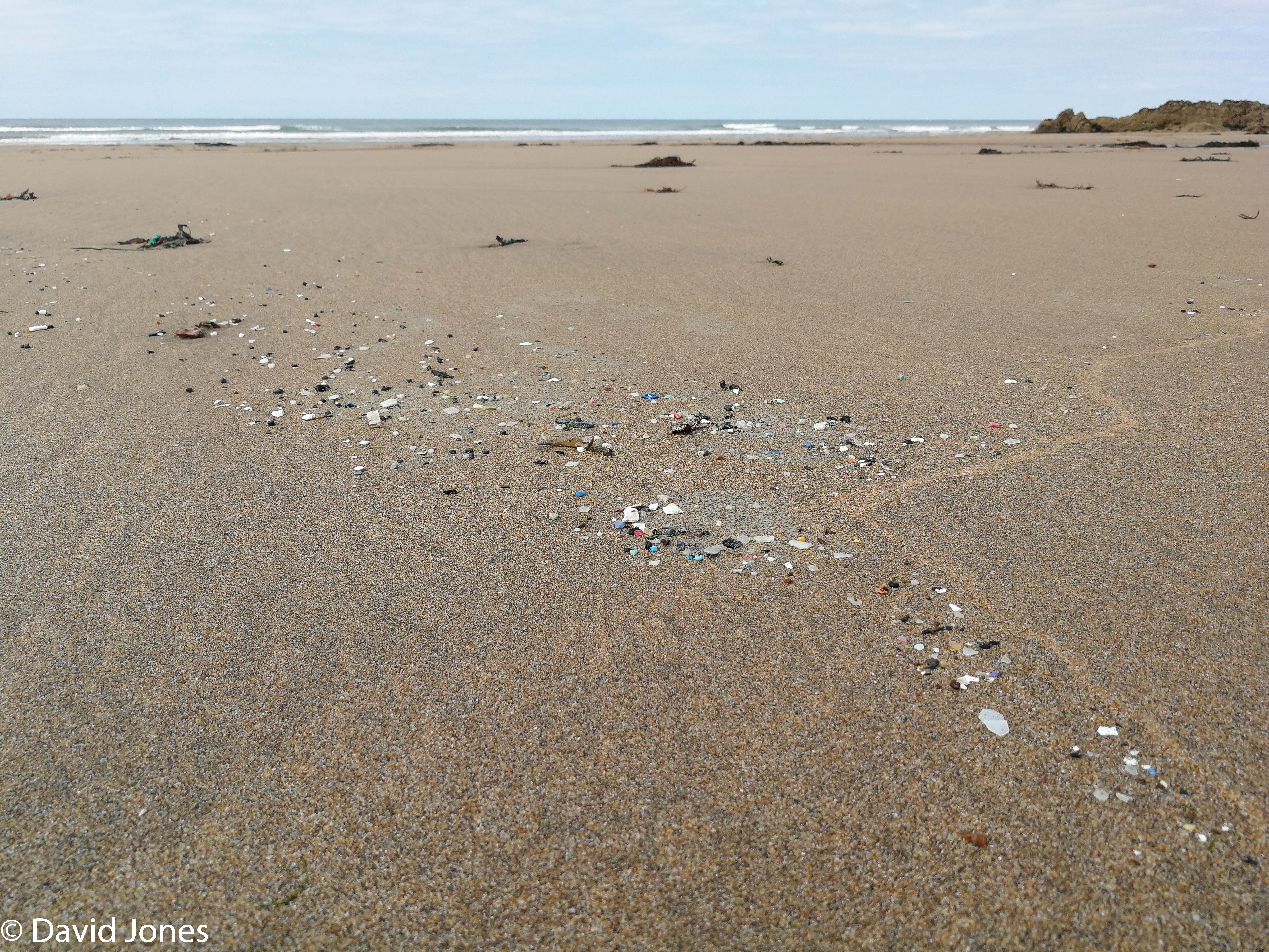 microplastics following a waveline in the sand